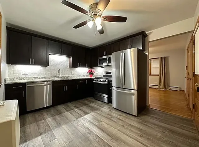 a kitchen with a refrigerator a sink and dishwasher