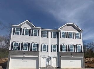 a front view of a house with a garage