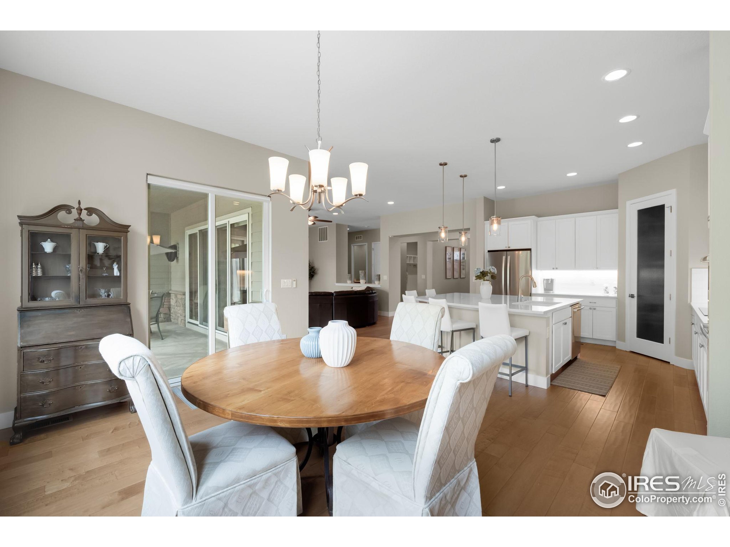 5799 Howell Street Golden, CO 80403 - Photo 13 of 50 a dining room with furniture a chandelier and wooden floor