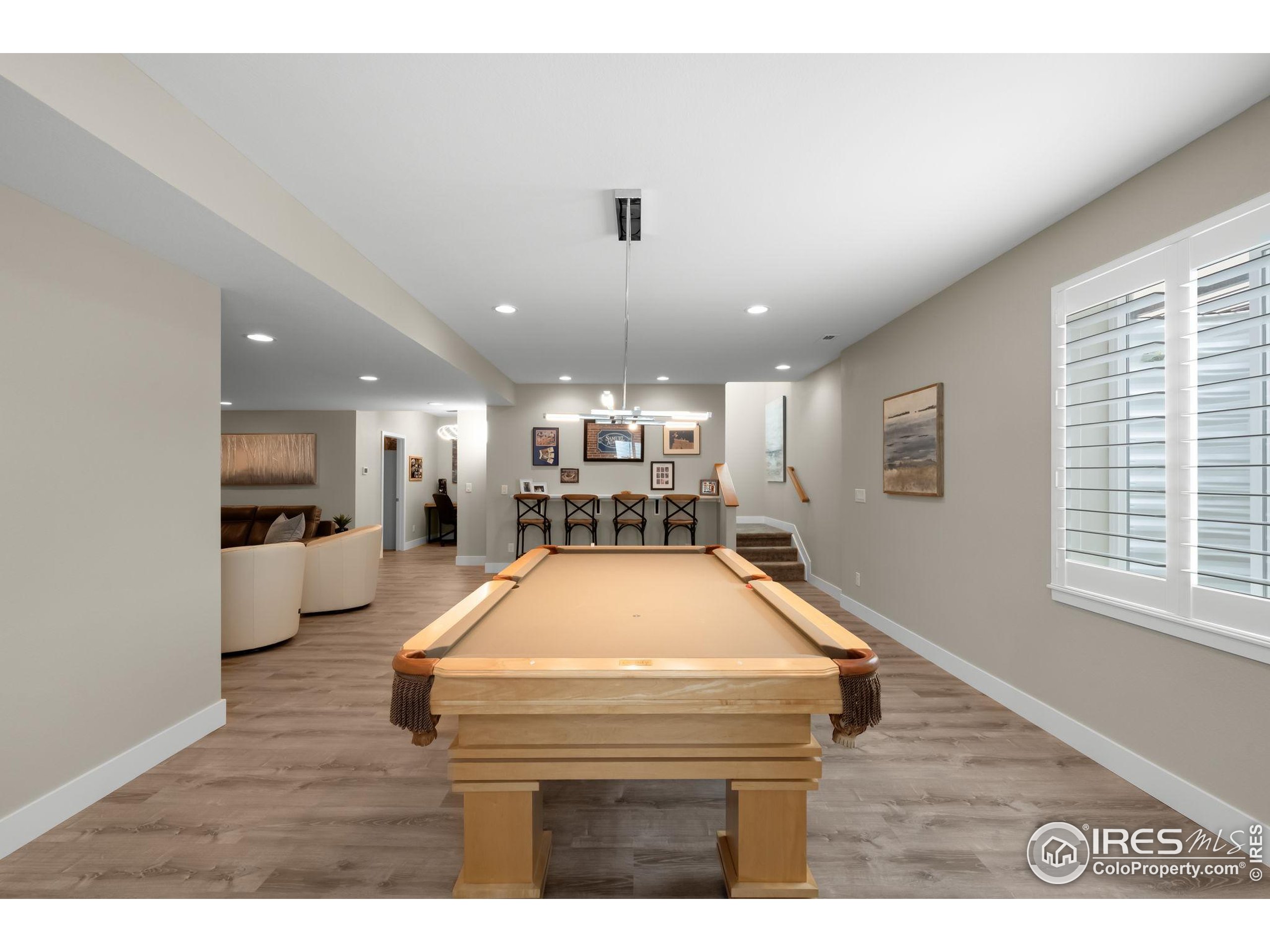 5799 Howell Street Golden, CO 80403 - Photo 16 of 50 a living room with stainless steel appliances kitchen island granite countertop furniture and a wooden floor