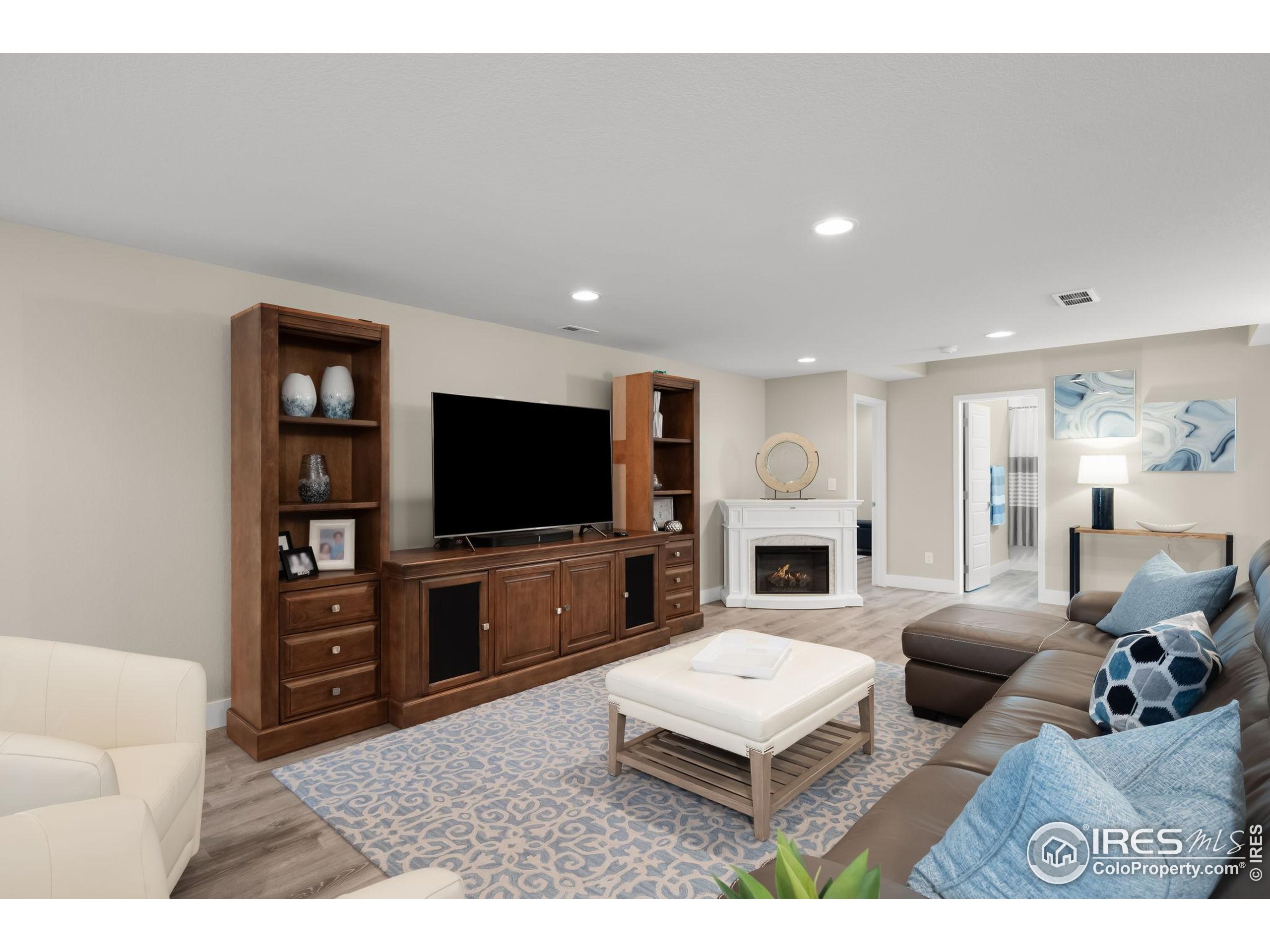 5799 Howell Street Golden, CO 80403 - Photo 18 of 50 a living room with furniture a flat screen tv and a fireplace