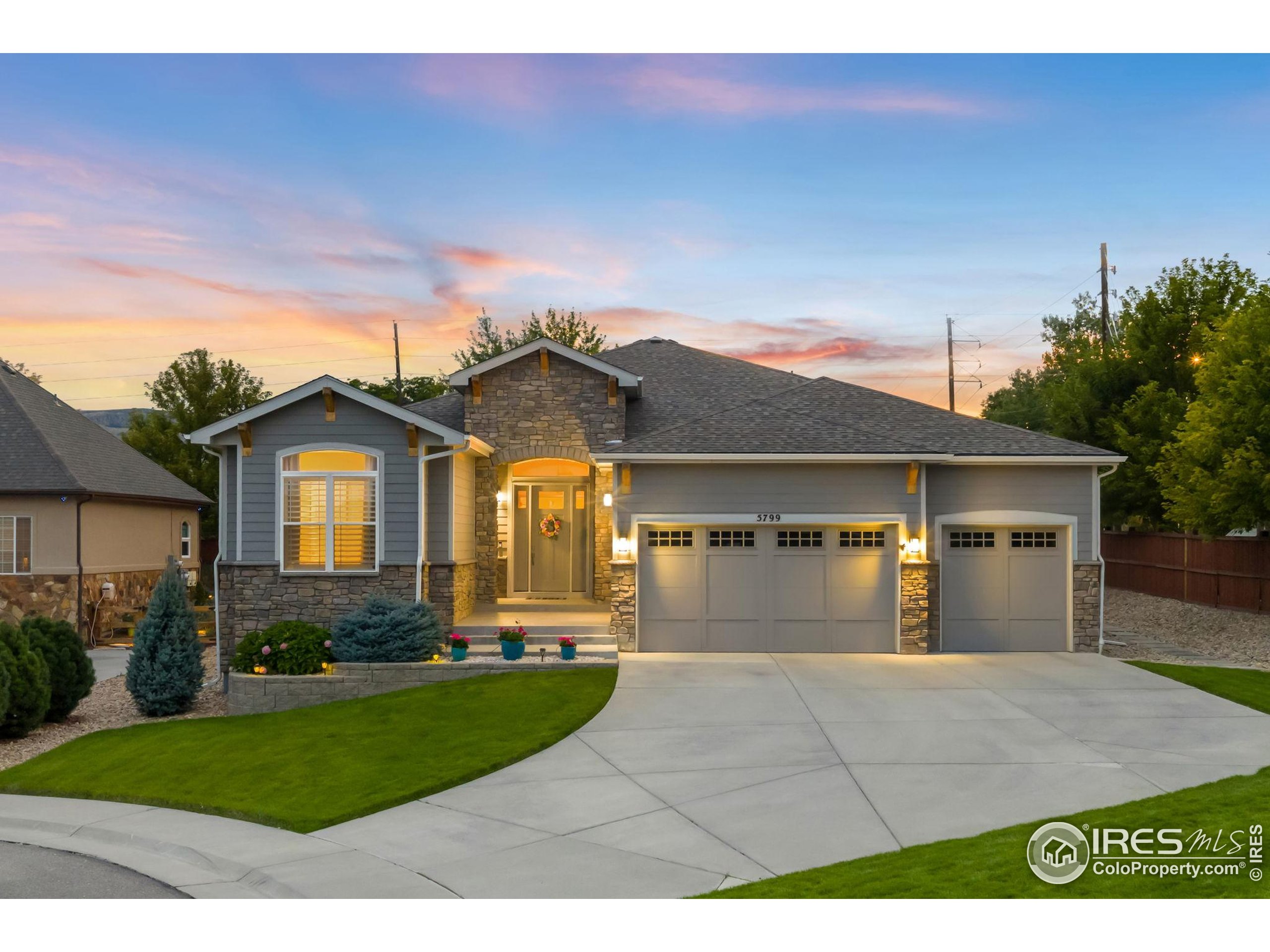 5799 Howell Street Golden, CO 80403 - Photo 2 of 50 a front view of a house with a yard and garage