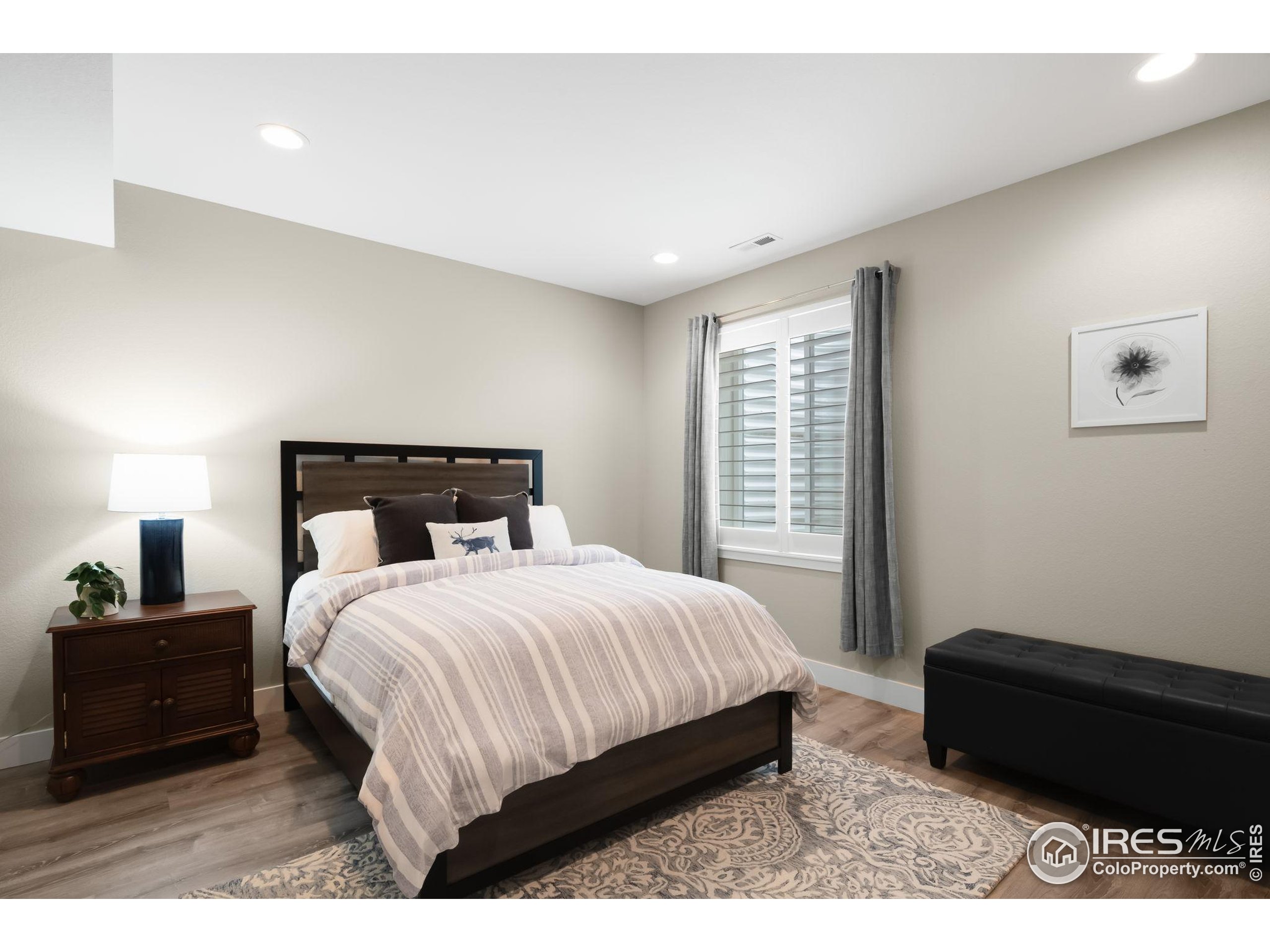 5799 Howell Street Golden, CO 80403 - Photo 22 of 50 a bedroom with a bed and a night stand