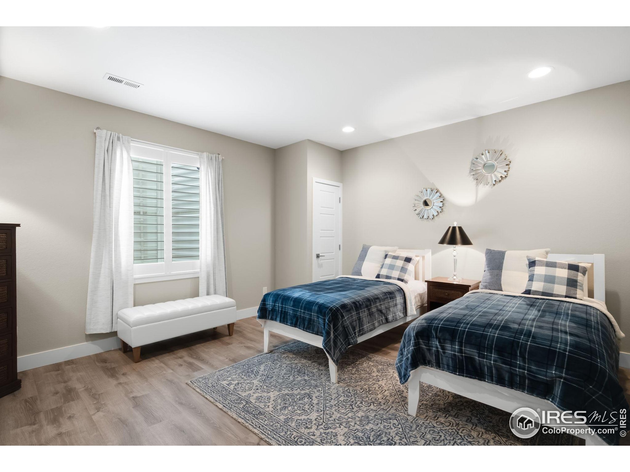 5799 Howell Street Golden, CO 80403 - Photo 23 of 50 a bedroom with two beds and a large mirror