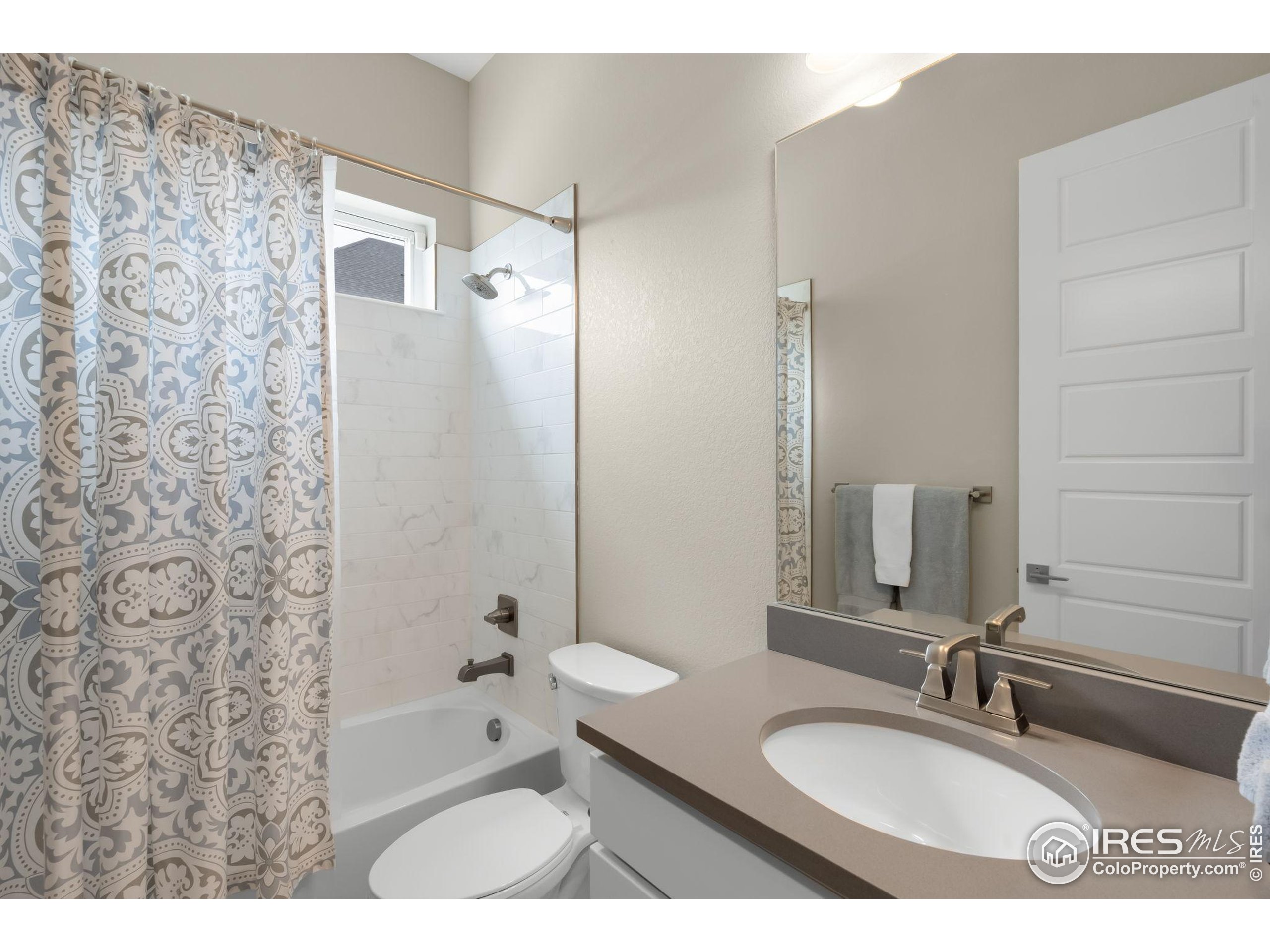 5799 Howell Street Golden, CO 80403 - Photo 27 of 50 a bathroom with a granite countertop sink toilet and shower