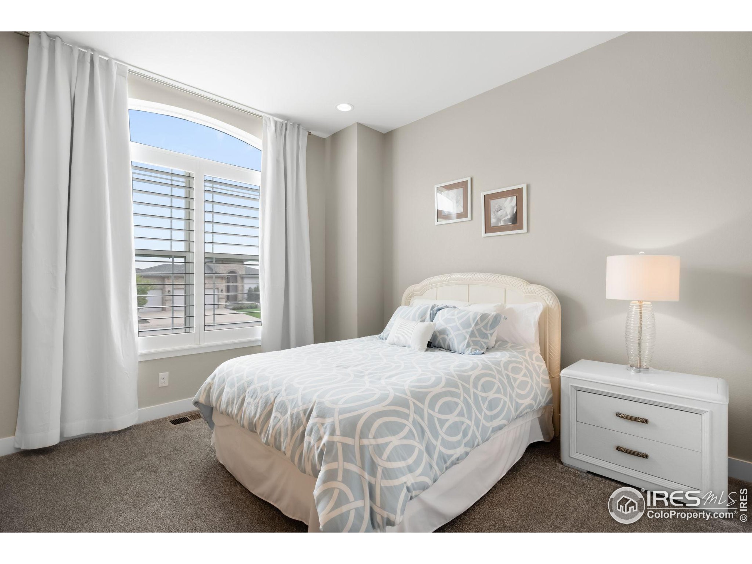 5799 Howell Street Golden, CO 80403 - Photo 28 of 50 a bedroom with a bed and a window