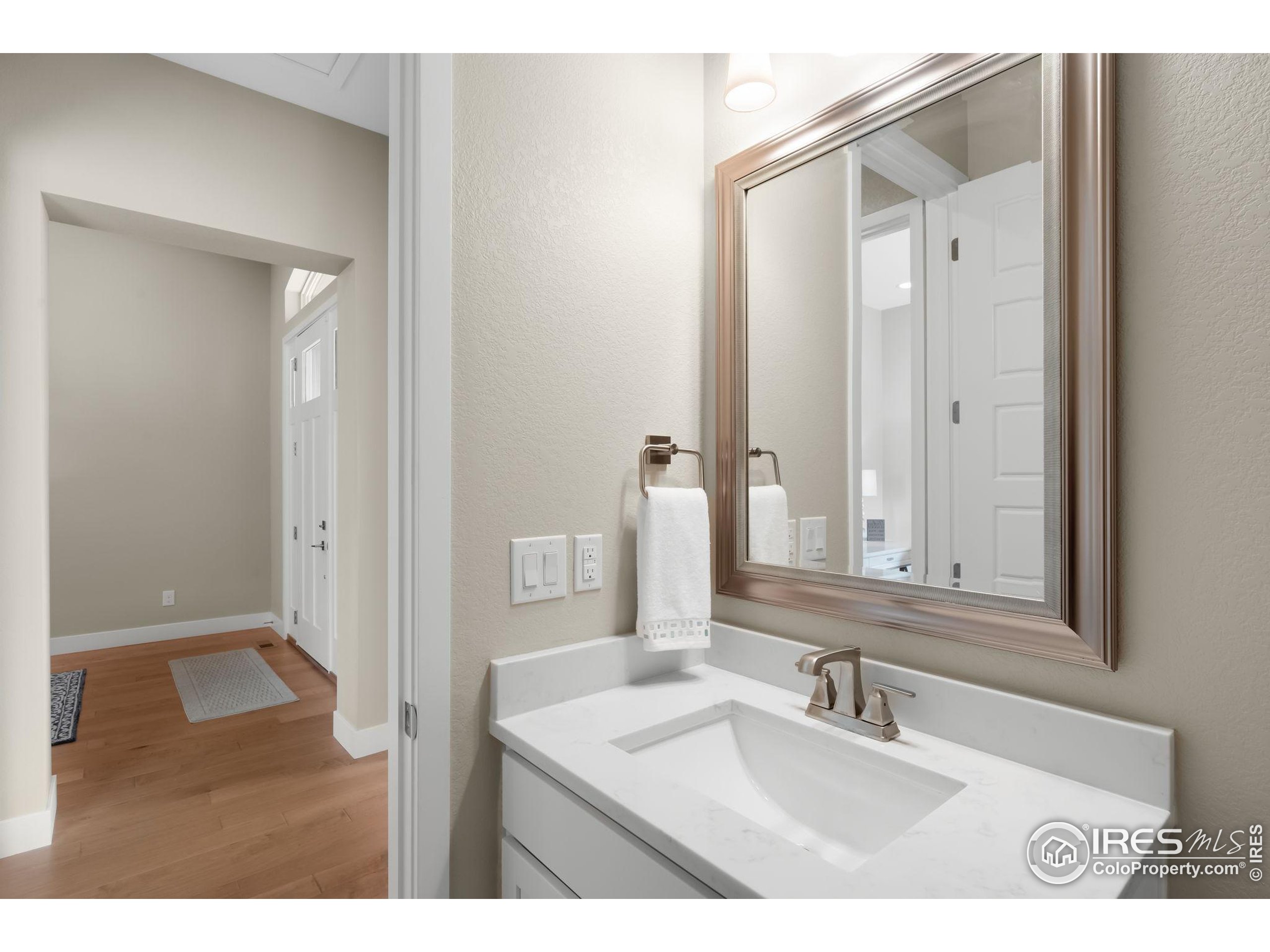 5799 Howell Street Golden, CO 80403 - Photo 29 of 50 a bathroom with a sink a mirror and a vanity