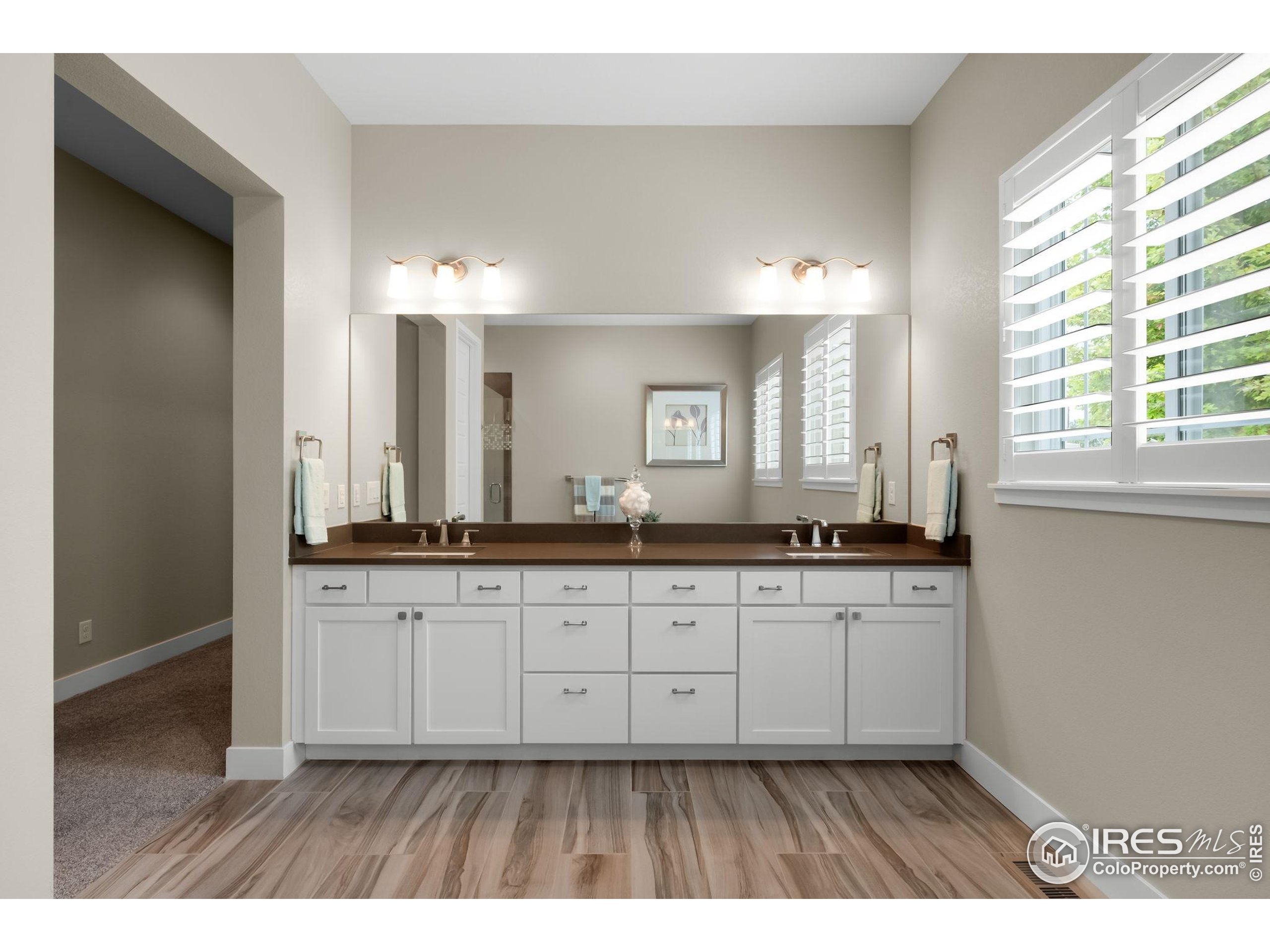5799 Howell Street Golden, CO 80403 - Photo 30 of 50 a bathroom with double sink large mirror and a window