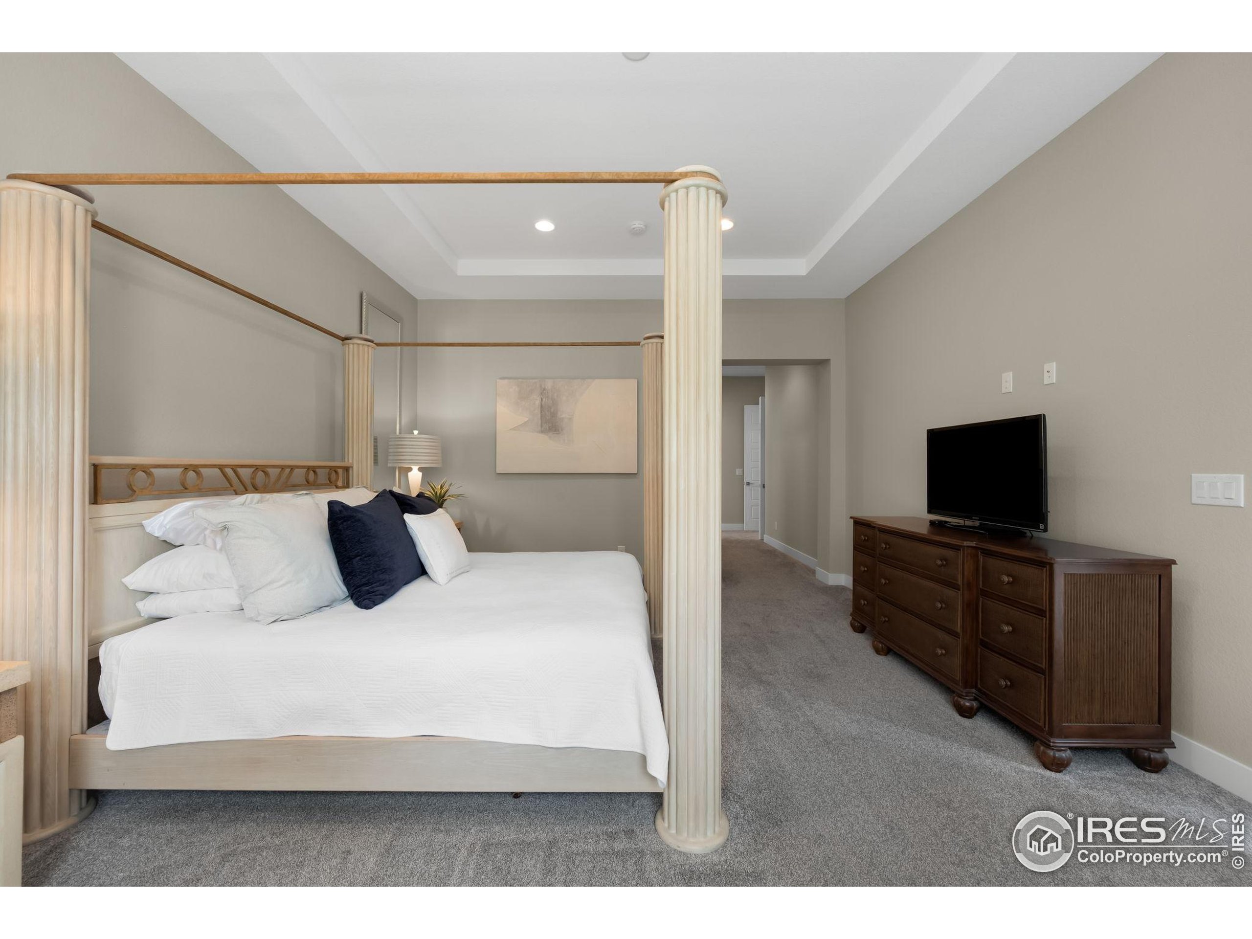 5799 Howell Street Golden, CO 80403 - Photo 34 of 50 a bedroom with a large bed and a flat screen tv