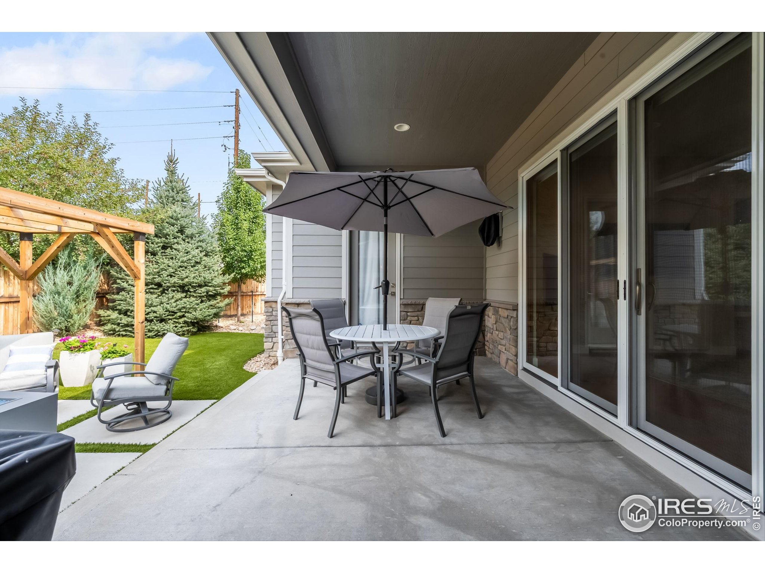 5799 Howell Street Golden, CO 80403 - Photo 35 of 50 a view of a patio with table and chairs potted plants with floor to ceiling window