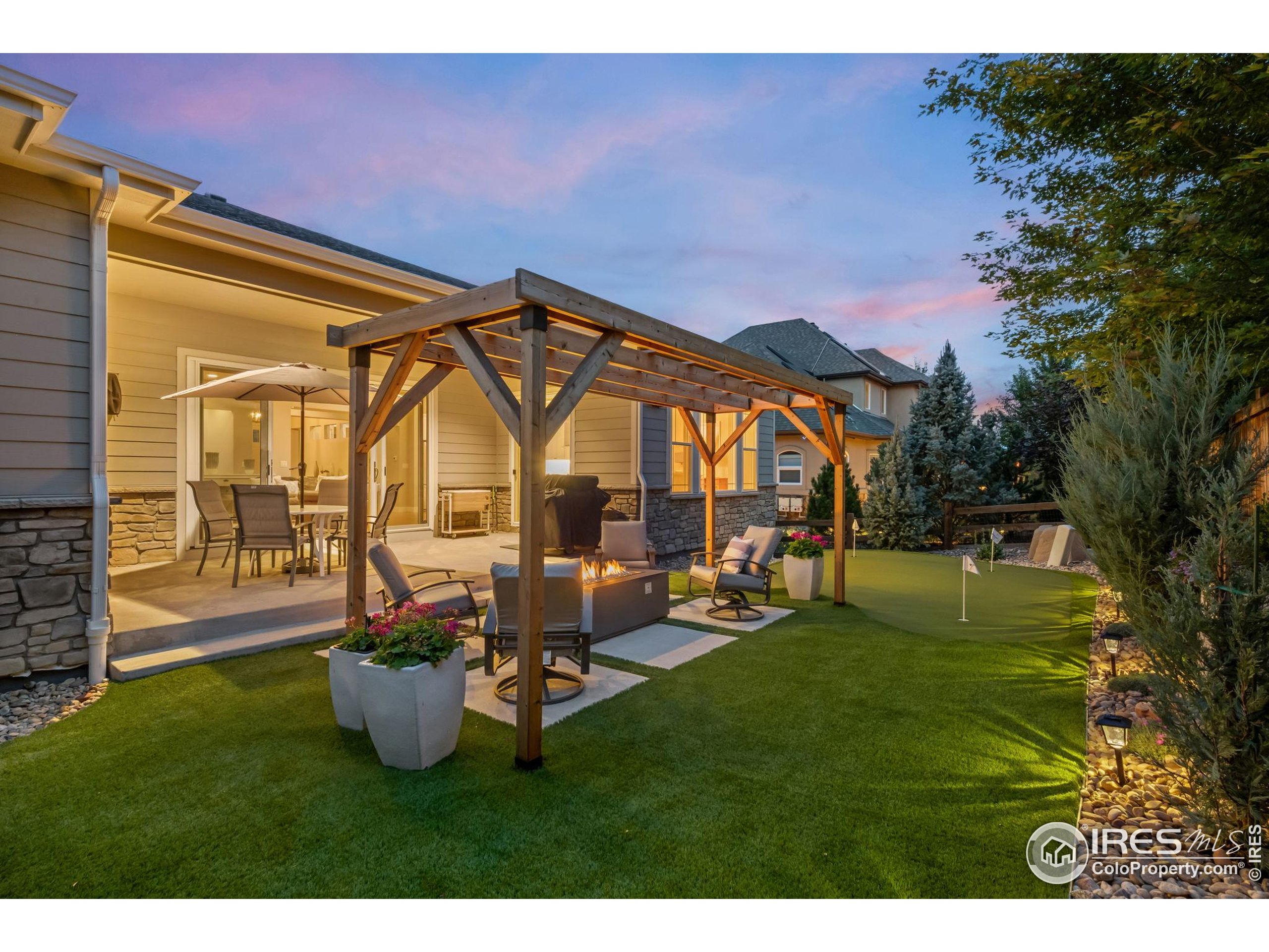 5799 Howell Street Golden, CO 80403 - Photo 40 of 50 a backyard of a house with table and chairs