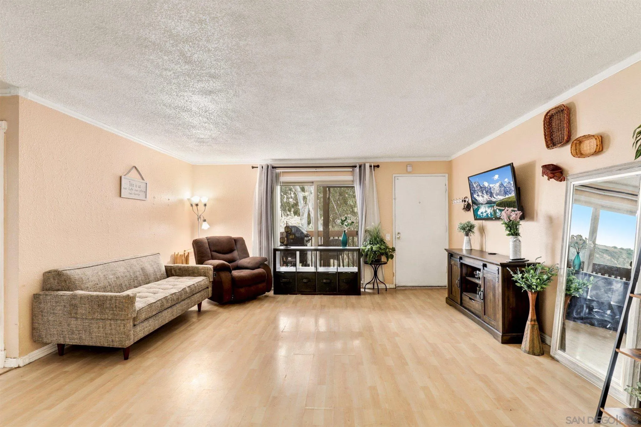 6370 Rancho Mission Road, Unit 920 San Diego, CA 92108 - Photo 1 of 22 a living room with furniture and a flat screen tv