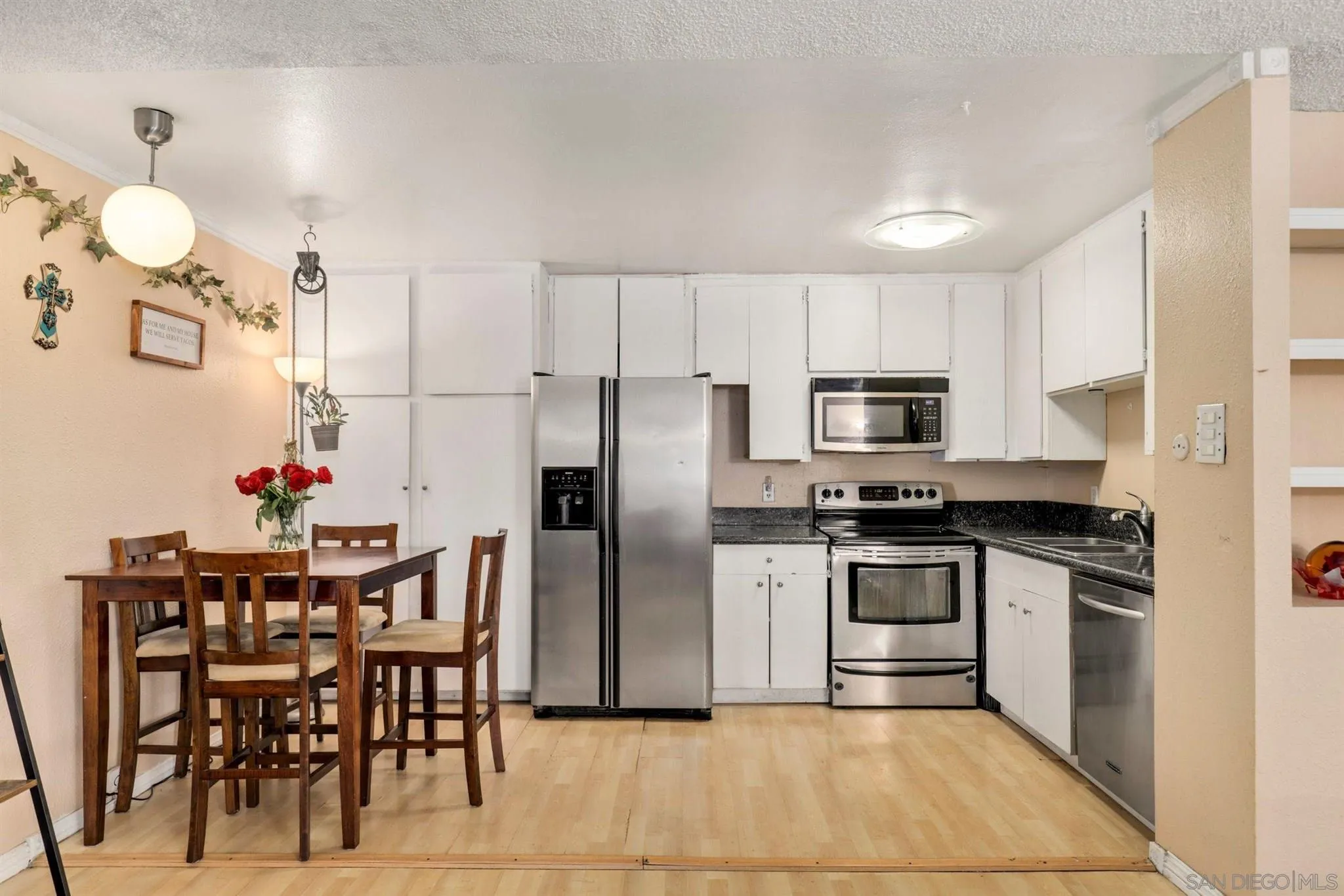6370 Rancho Mission Road, Unit 920 San Diego, CA 92108 - Photo 4 of 22 a kitchen with stainless steel appliances granite countertop a stove top oven a sink dishwasher and a refrigerator