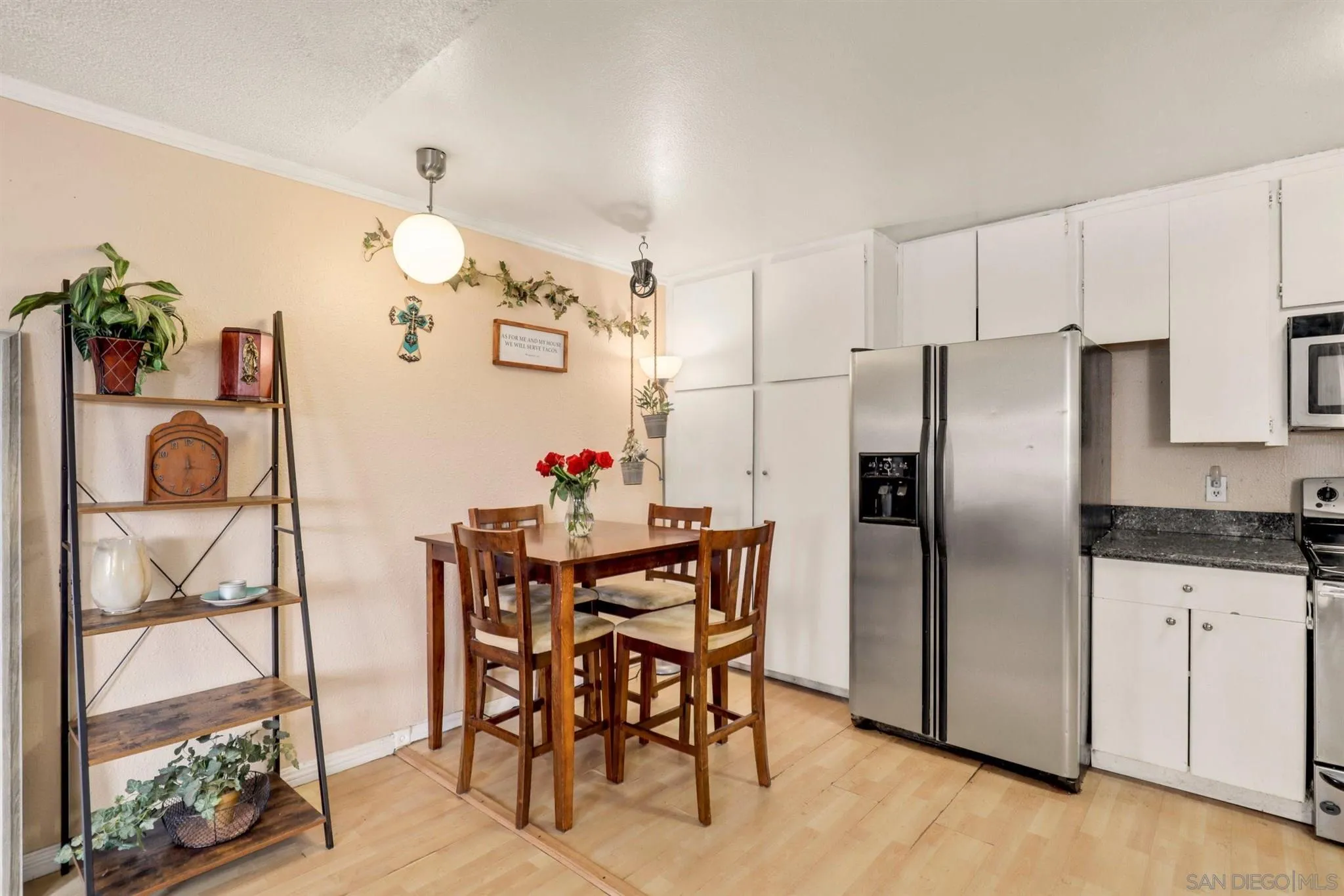 6370 Rancho Mission Road, Unit 920 San Diego, CA 92108 - Photo 7 of 22 a kitchen with granite countertop a refrigerator and microwave