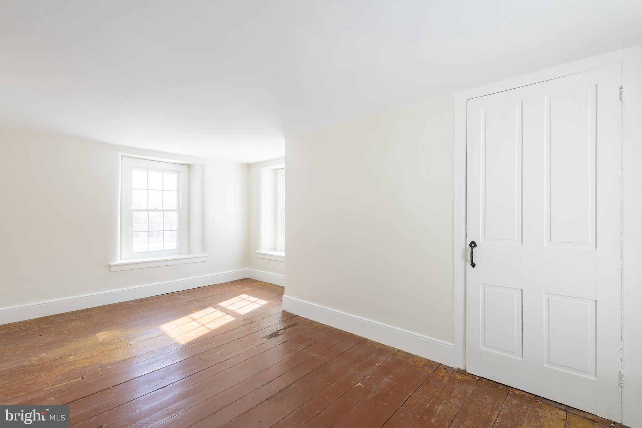 1301 Stump Road North Wales, PA 19454 - Photo 16 of 19 a view of an empty room with wooden floor and a window