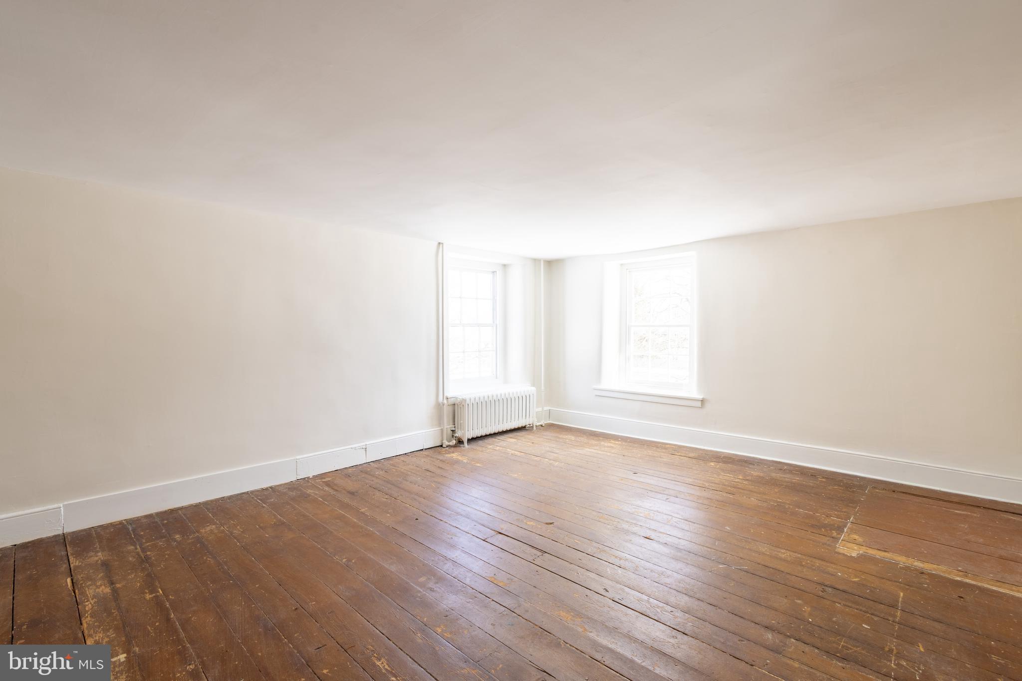 1301 Stump Road North Wales, PA 19454 - Photo 18 of 19 a view of an empty room with wooden floor and a window