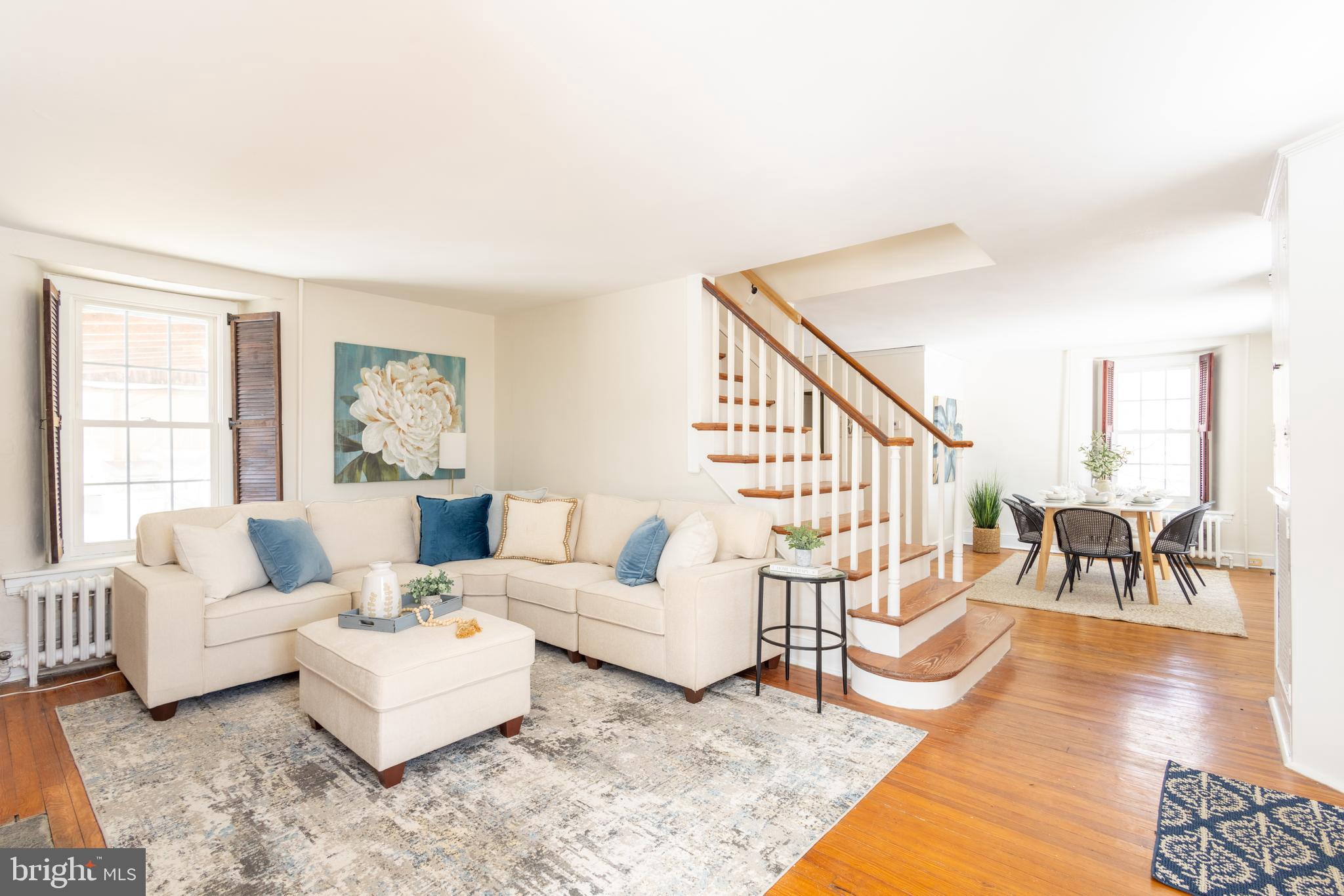 1301 Stump Road North Wales, PA 19454 - Photo 2 of 19 a living room with furniture and a dining table with wooden floor