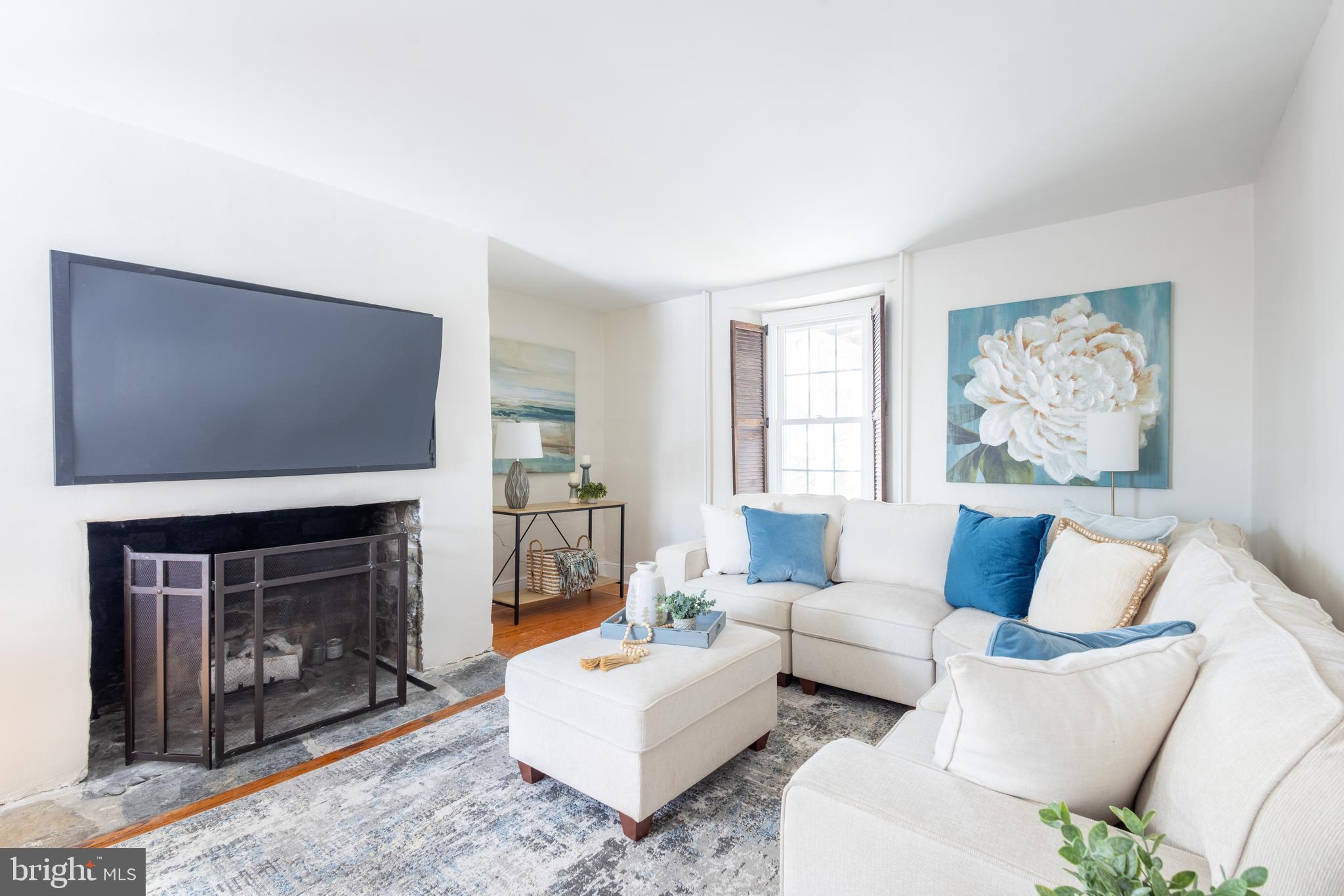 1301 Stump Road North Wales, PA 19454 - Photo 3 of 19 a living room with furniture a fireplace and a flat screen tv