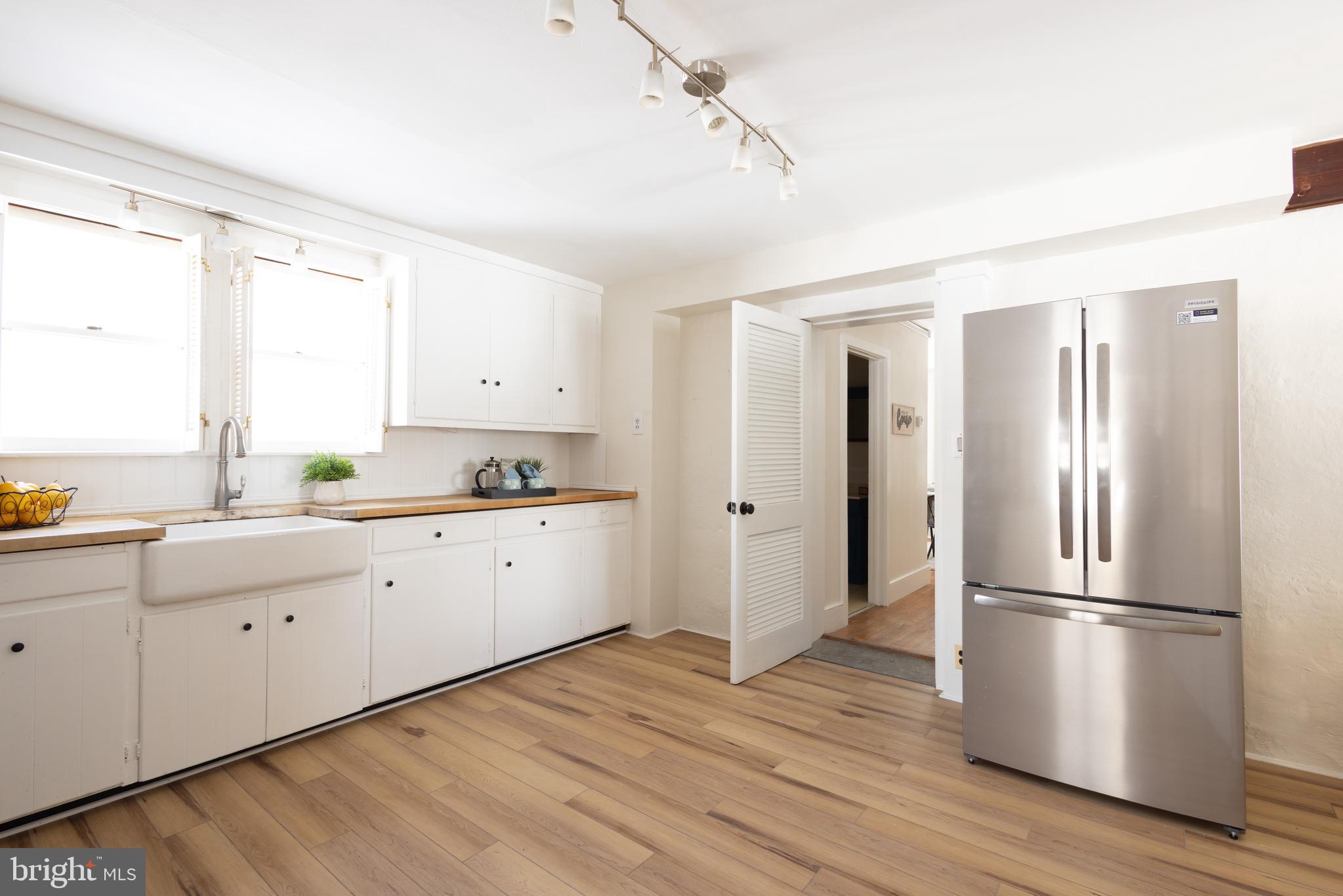 1301 Stump Road North Wales, PA 19454 - Photo 9 of 19 a kitchen with a refrigerator and white cabinets