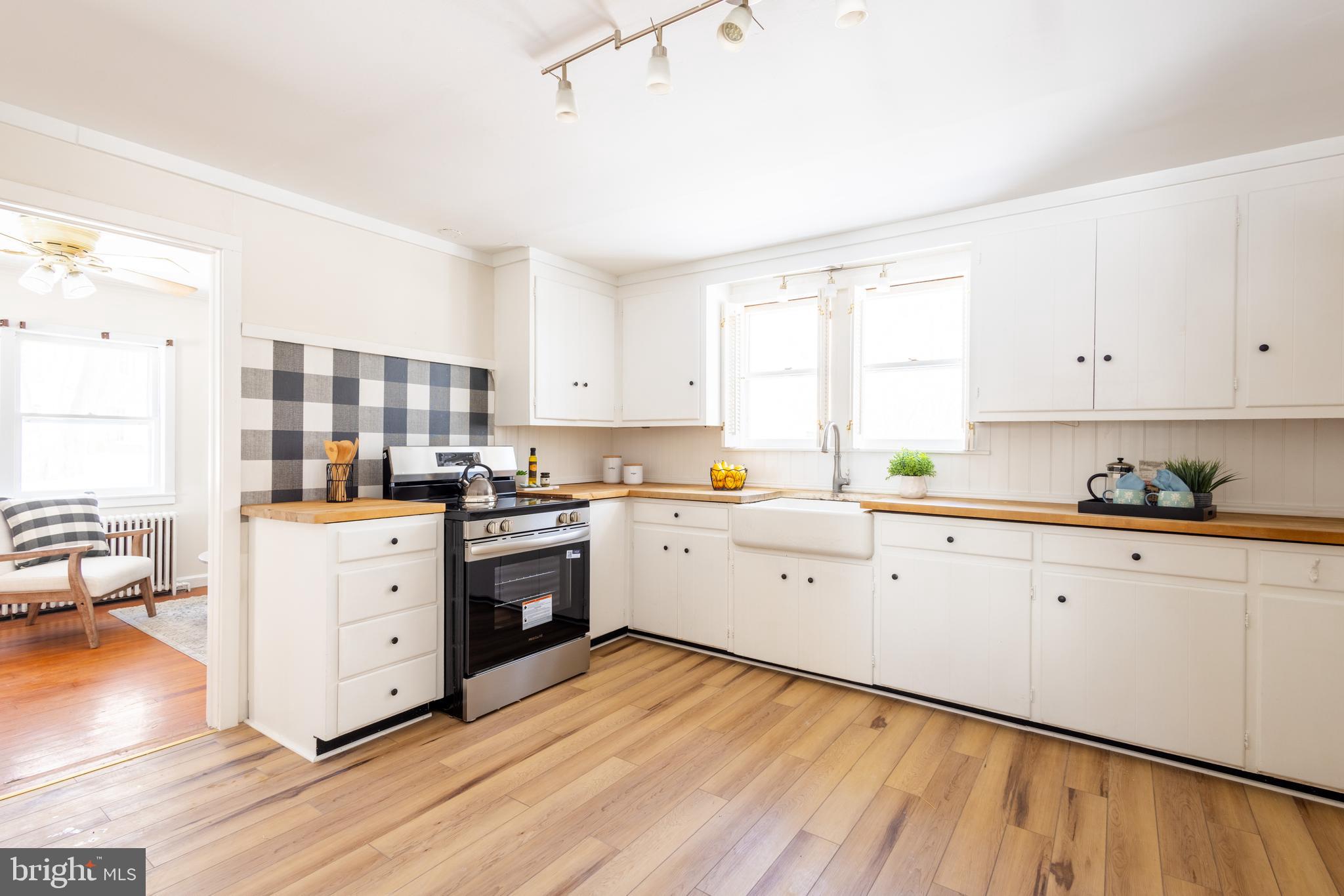 1301 Stump Road North Wales, PA 19454 - Photo 10 of 19 a kitchen with cabinets stainless steel appliances a sink and wooden floor