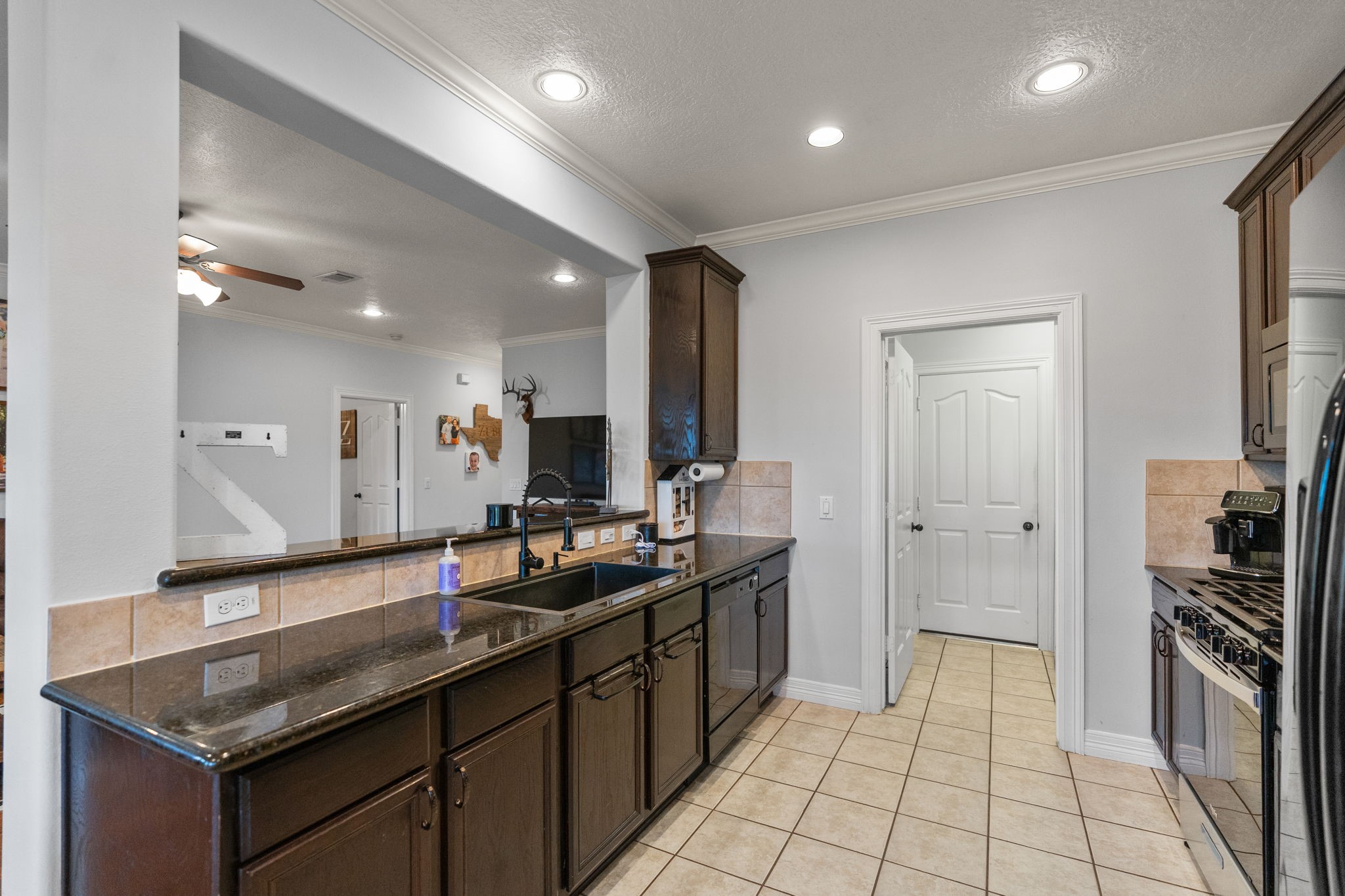 5942 Wildflower Road Sealy, TX 77474 - Photo 10 of 41 a kitchen with stainless steel appliances granite countertop a sink stove and refrigerator