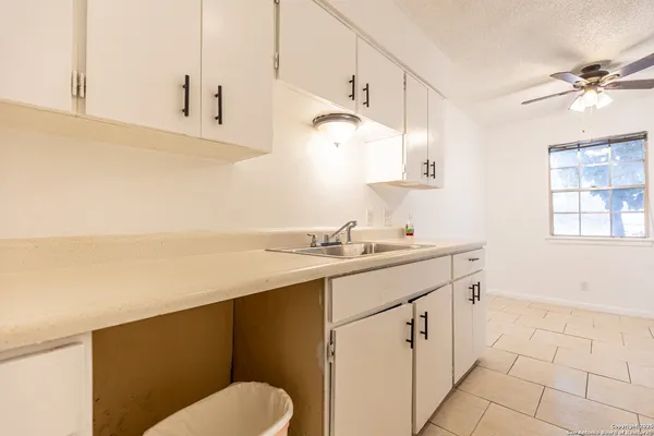 a bathroom with a sink vanity granite and toilet
