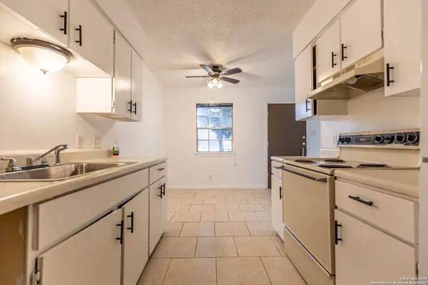 a kitchen with stainless steel appliances granite countertop a sink a stove and refrigerator
