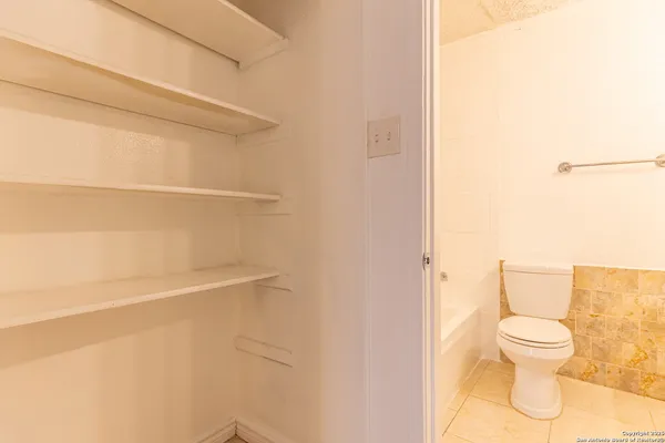 a white toilet sitting next to a bathroom sink