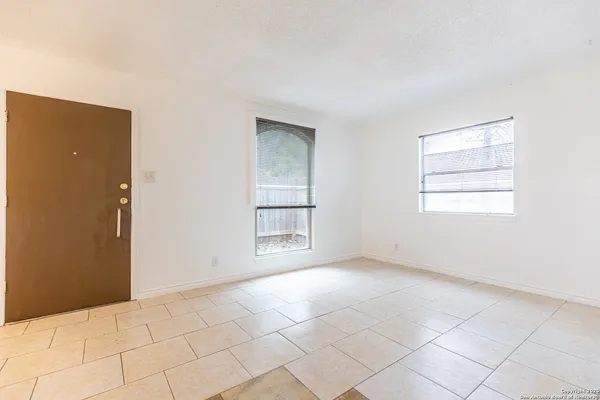 an empty room with windows and closet