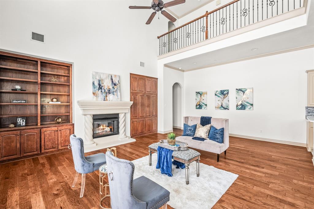 6393 Burnham Street Frisco, TX 75034 - Photo 18 of 30 a living room with furniture and a fireplace