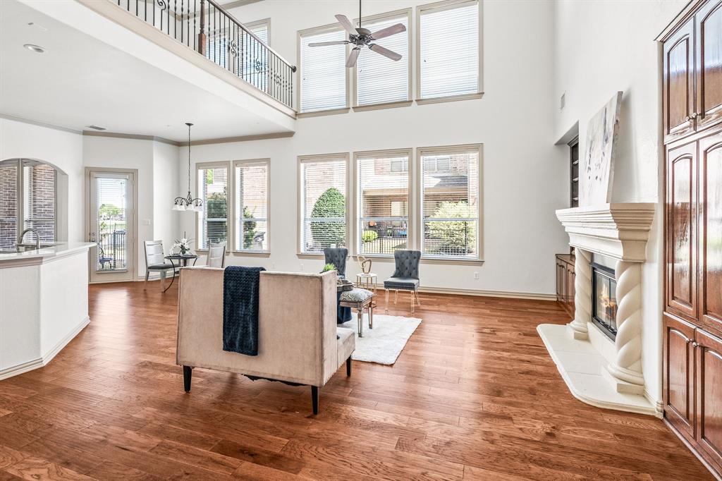 6393 Burnham Street Frisco, TX 75034 - Photo 19 of 30 a living room with fireplace furniture and a large window