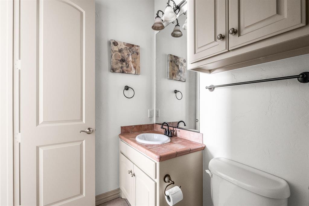 6393 Burnham Street Frisco, TX 75034 - Photo 21 of 30 a bathroom with a toilet sink and mirror