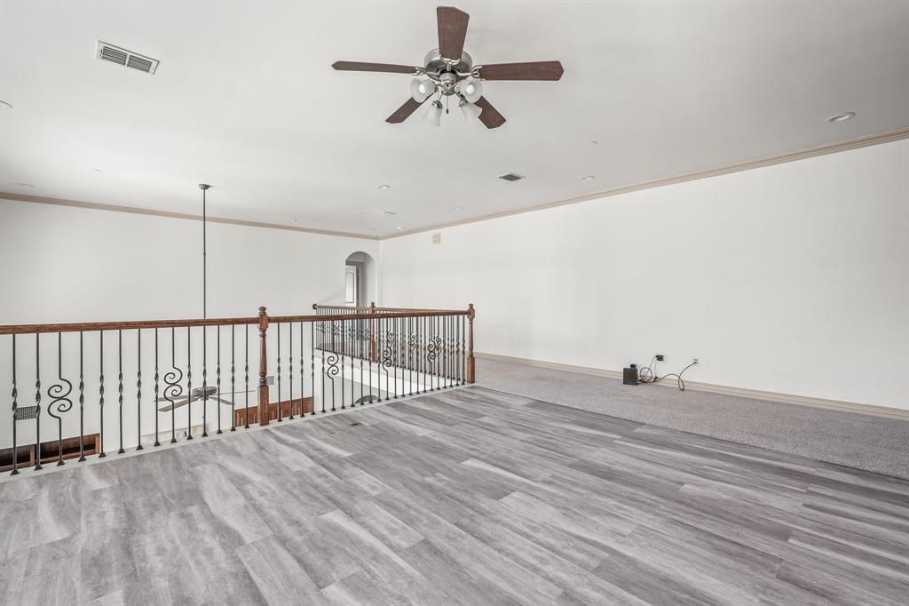 6393 Burnham Street Frisco, TX 75034 - Photo 25 of 30 a view of a livingroom with a ceiling fan and hardwood floor