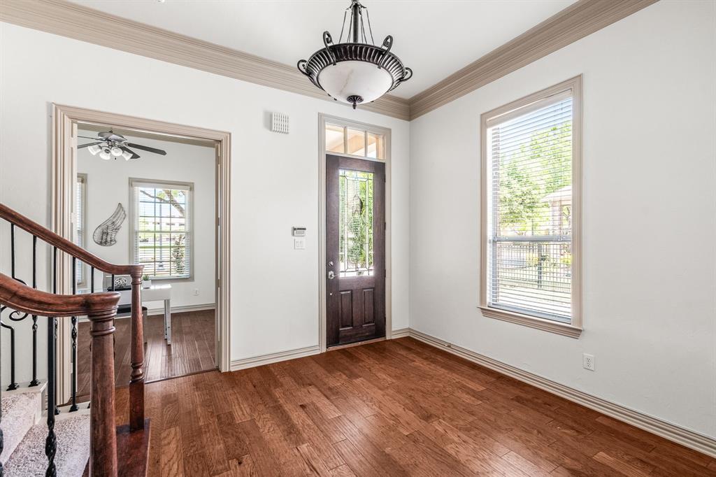 6393 Burnham Street Frisco, TX 75034 - Photo 9 of 30 a view of an empty room with a window and wooden floor