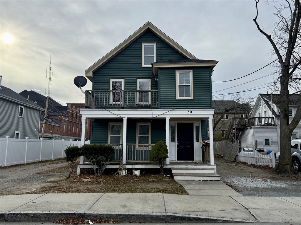 30 Sanger Street, Unit 1 Framingham, MA 01702 - Photo 1 of 15 a view of a house with a yard and large tree