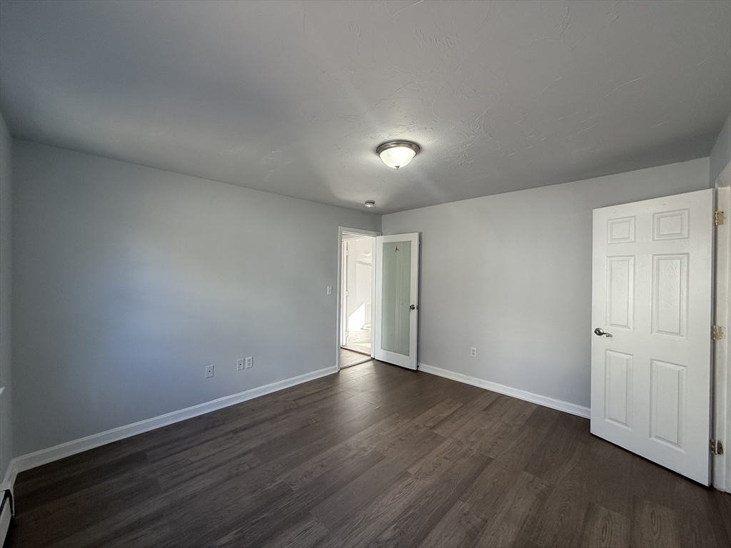 30 Sanger Street, Unit 1 Framingham, MA 01702 - Photo 12 of 15 a view of an empty room with wooden floor