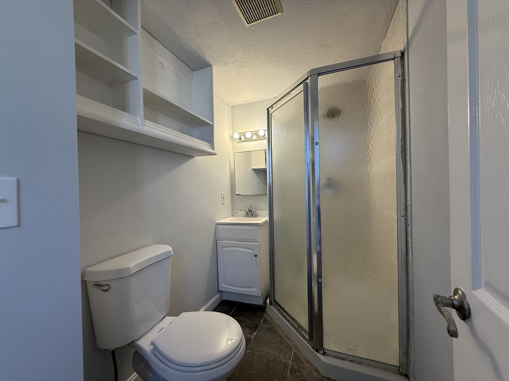 30 Sanger Street, Unit 1 Framingham, MA 01702 - Photo 15 of 15 a bathroom with a toilet and a shower