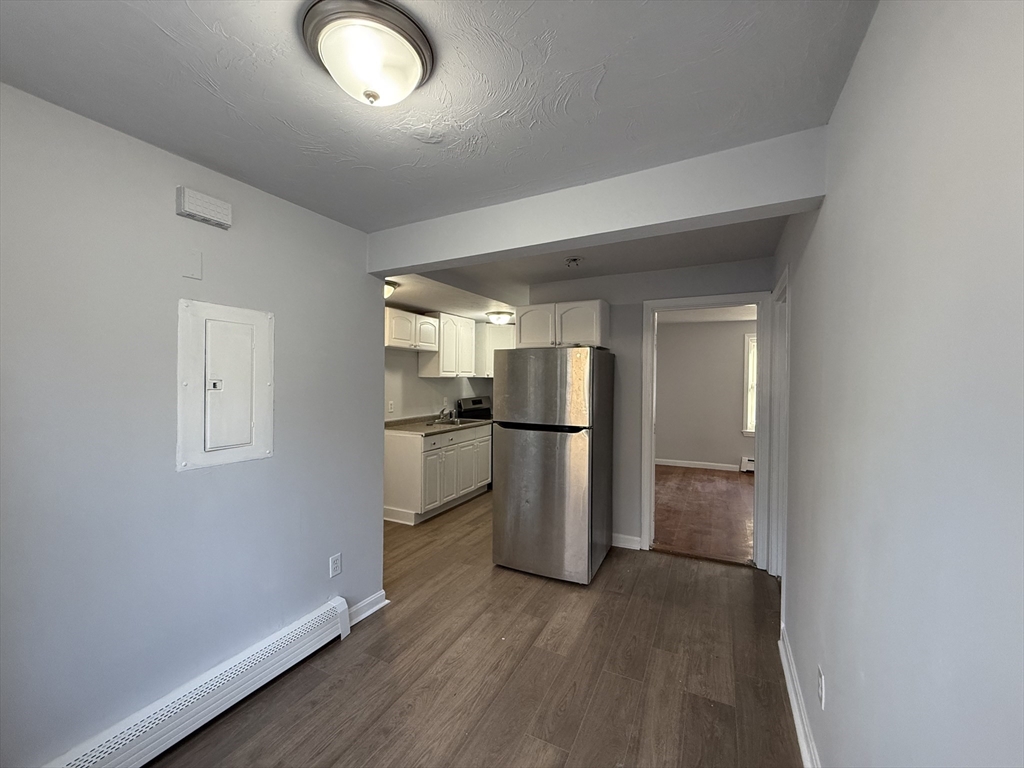 30 Sanger Street, Unit 1 Framingham, MA 01702 - Photo 3 of 15 a view of a kitchen with a sink refrigerator and wooden floor