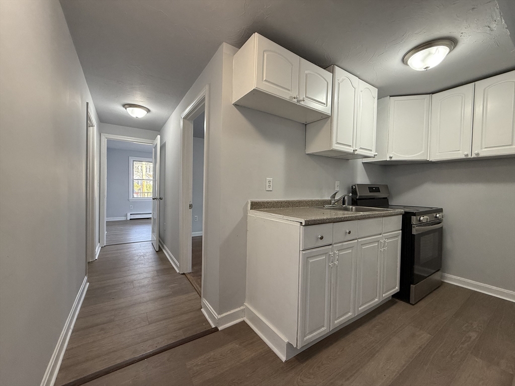 30 Sanger Street, Unit 1 Framingham, MA 01702 - Photo 4 of 15 a kitchen with stainless steel appliances granite countertop a stove a sink and a refrigerator