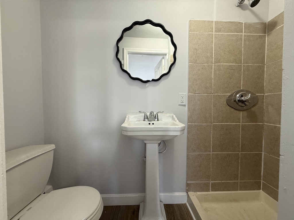 30 Sanger Street, Unit 1 Framingham, MA 01702 - Photo 6 of 15 a bathroom with a sink toilet and a mirror