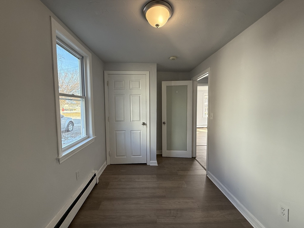 30 Sanger Street, Unit 1 Framingham, MA 01702 - Photo 8 of 15 a view of livingroom with window and wooden floor