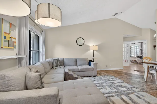 a living room with furniture a table and chairs