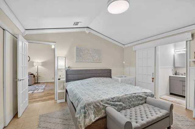 a spacious bedroom with a bed and a couch