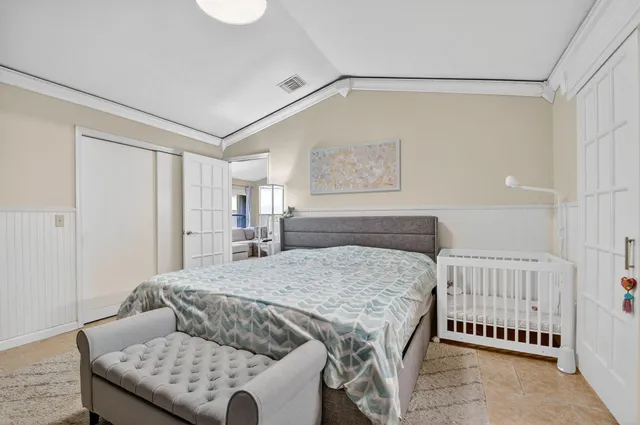 a bedroom with a bed and a couch