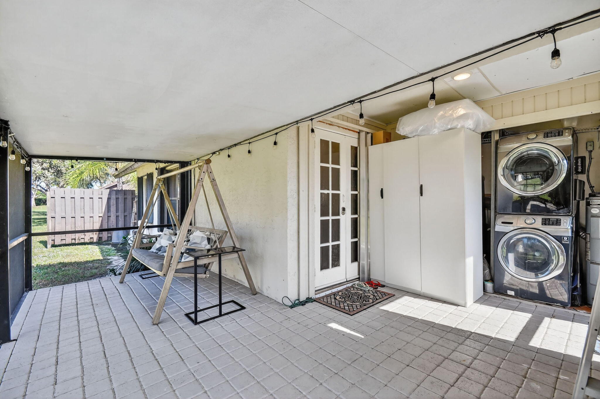 117 Vía De Casas Norte Boynton Beach, FL 33426 - Photo 23 of 31 a view of a storage & utility room with stairs wooden floor windows and a chandelier