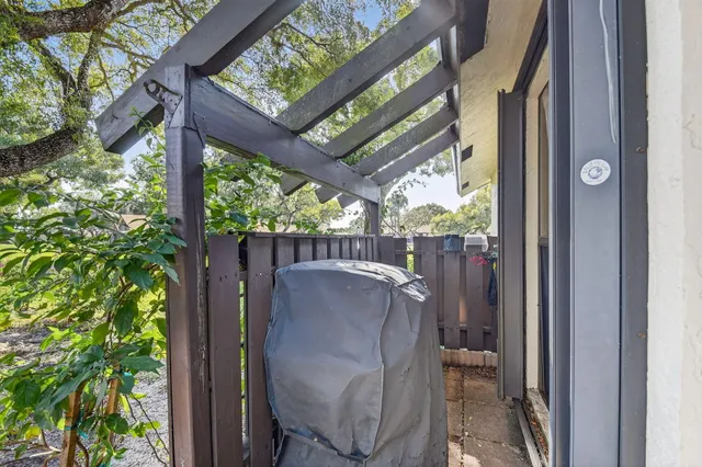 a view of a porch with furniture and a yard