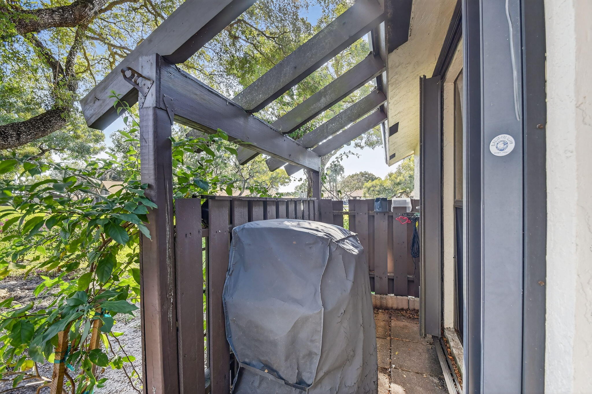 117 Vía De Casas Norte Boynton Beach, FL 33426 - Photo 3 of 31 a view of a porch with furniture and a yard