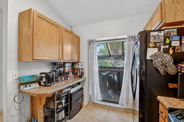 a kitchen with stainless steel appliances granite countertop a stove a refrigerator and a microwave