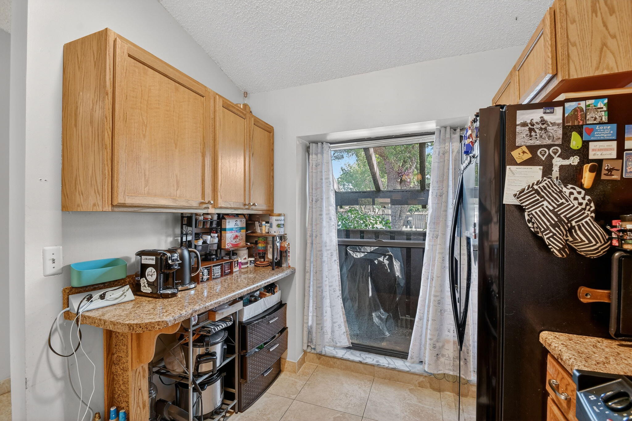 117 Vía De Casas Norte Boynton Beach, FL 33426 - Photo 7 of 31 a kitchen with stainless steel appliances granite countertop a stove a refrigerator and a microwave