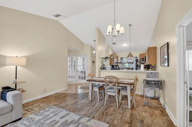 a view of a dining room with furniture and chandelier